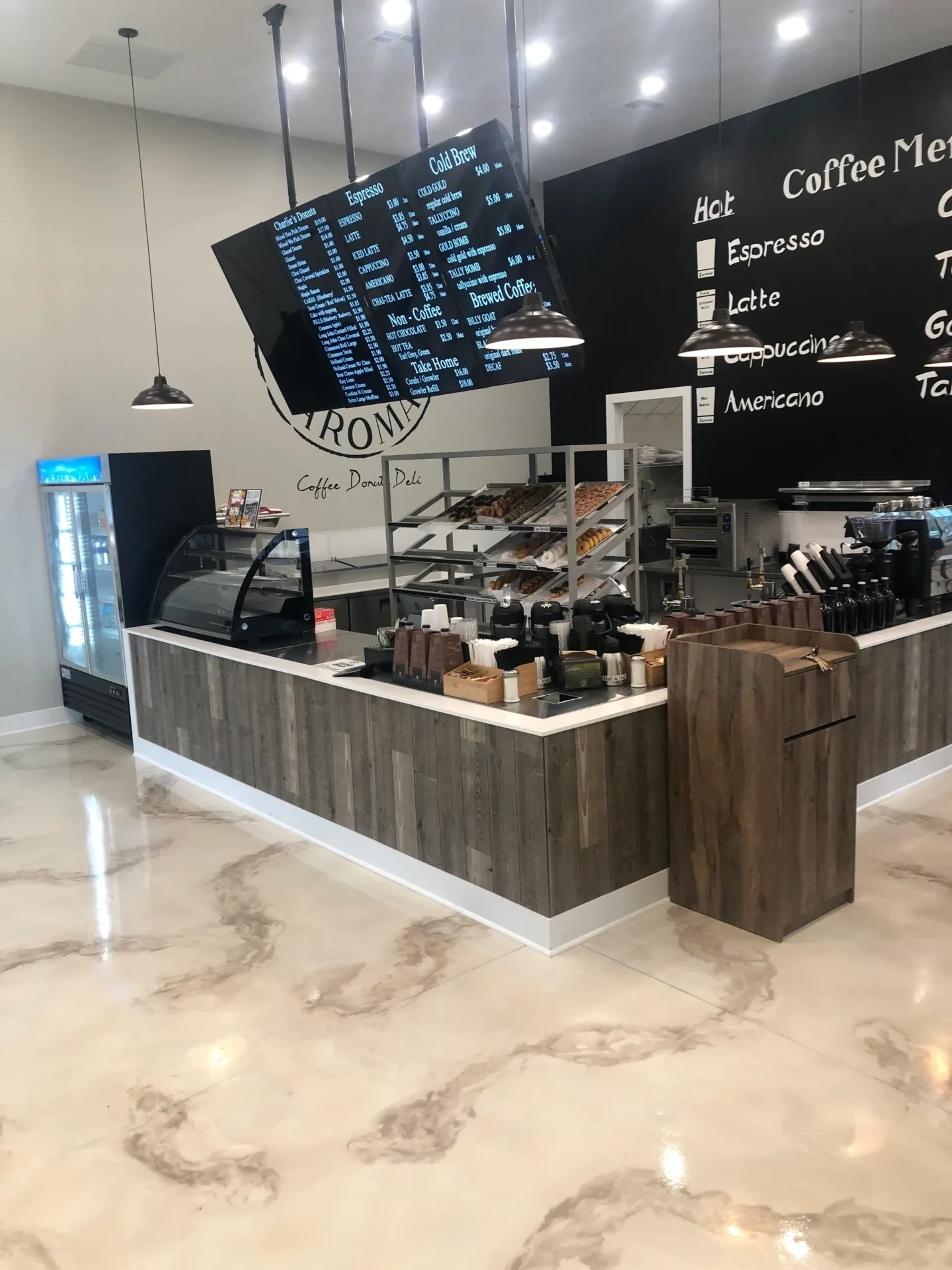A coffee shop with a counter and menu board.